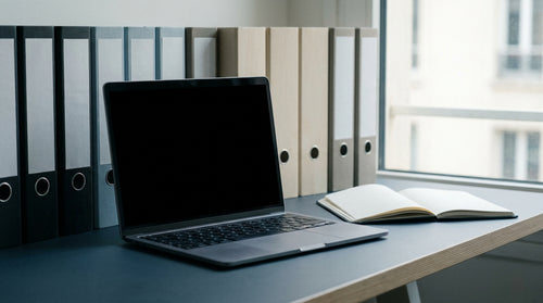 Un poste de travail professionnel avec un ordinateur portable et des dossiers